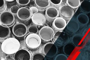 Top-down view of numerous open paint buckets arranged in a cluster in grayscale era image with varying paint levels inside each bucket.