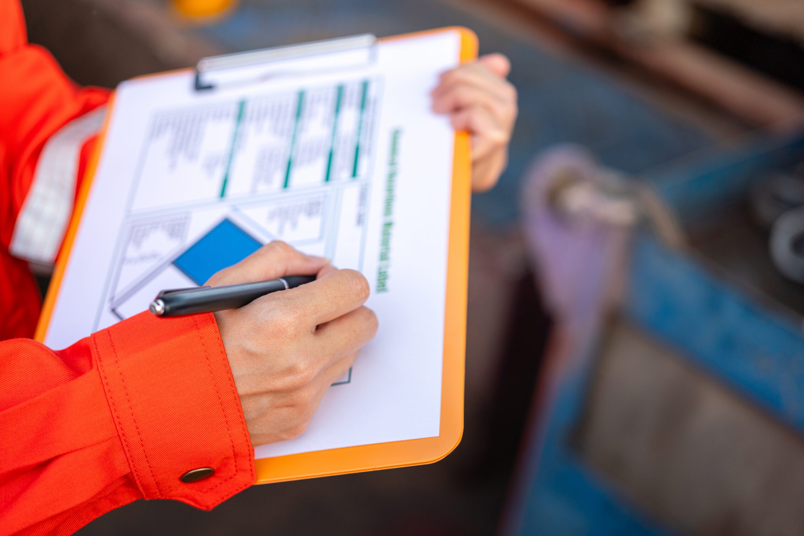 Person holding a clipboard and writing on RCRA Regulations